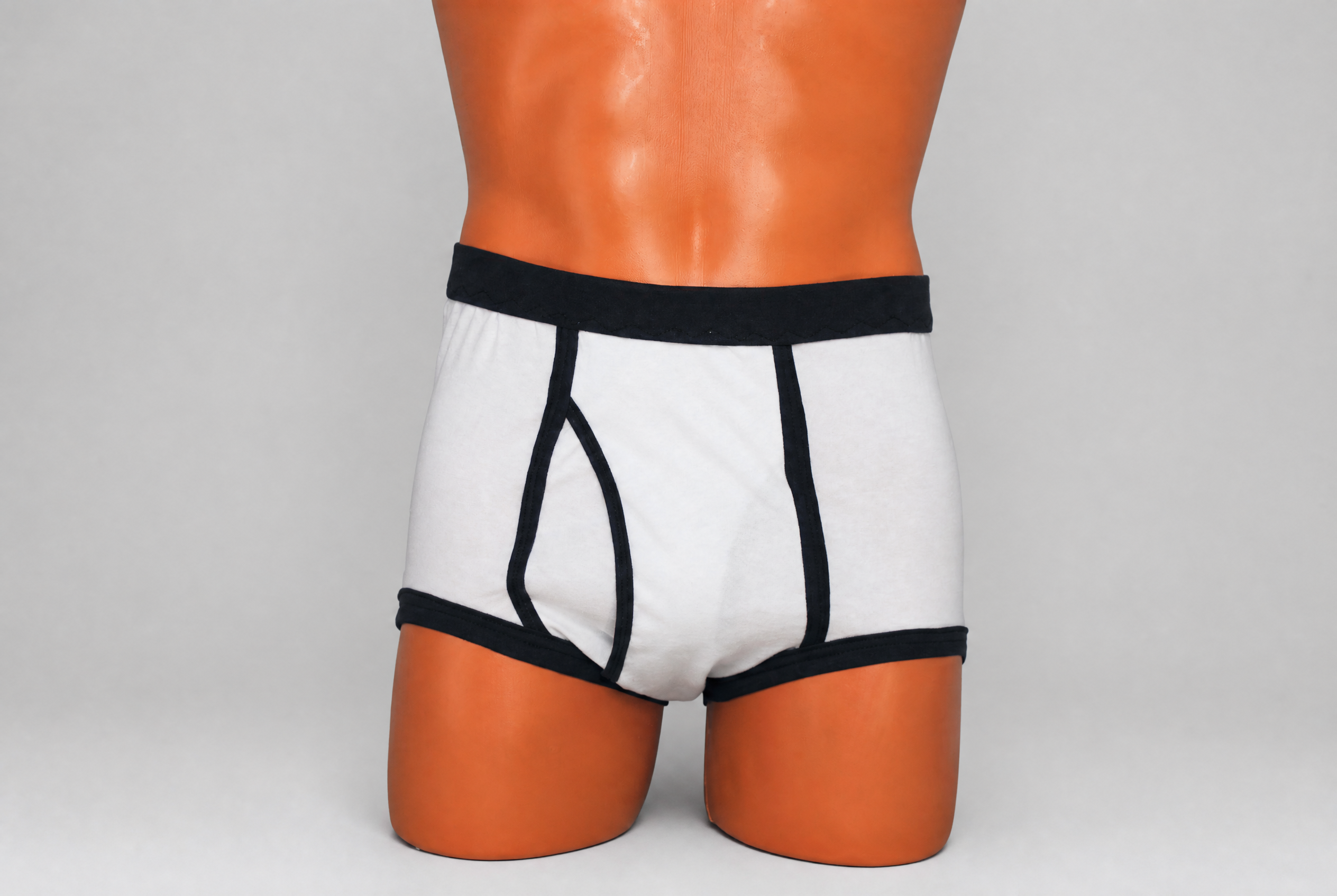 White and black retro double seat cotton briefs — front view showing Y-front opening and bold black contrast trim