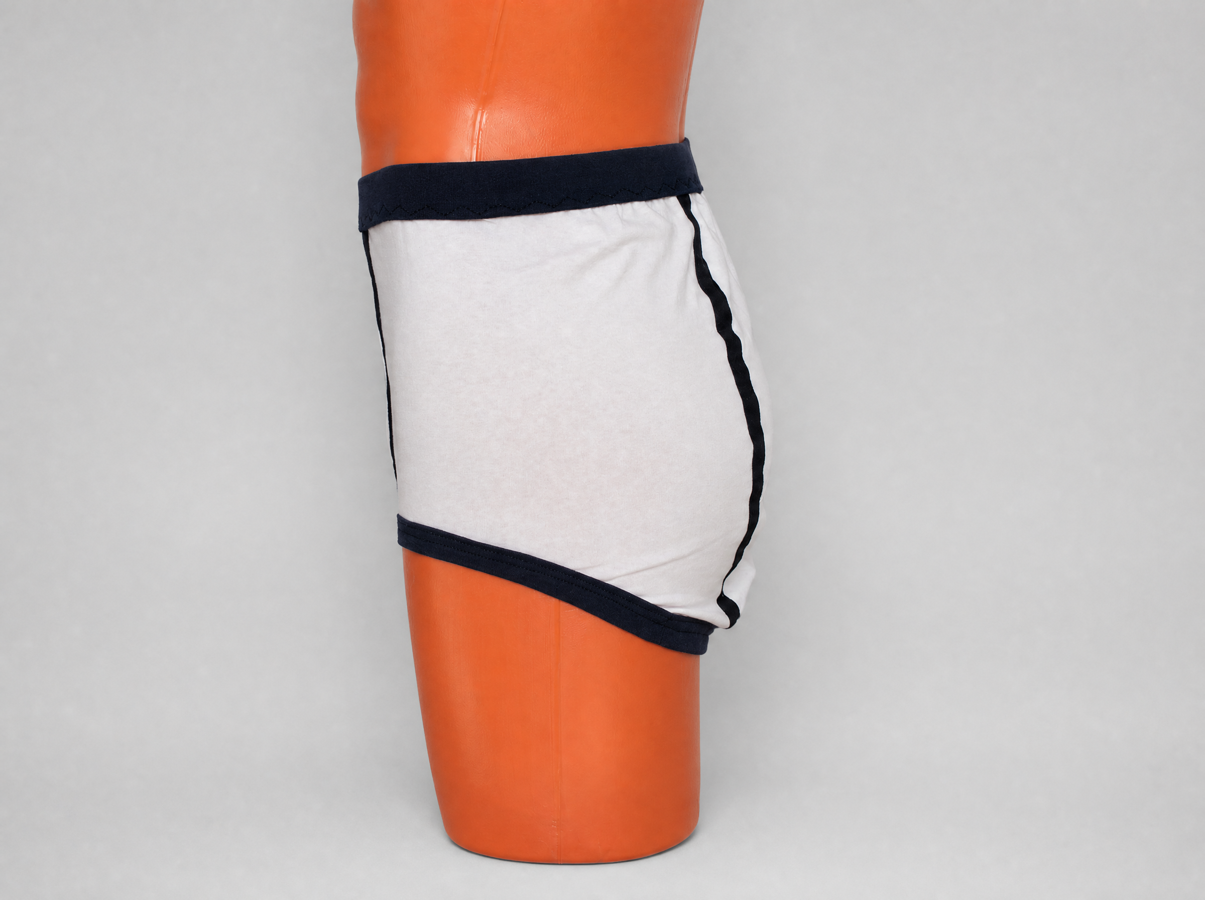 White and black retro double seat cotton briefs — side view showing generous cut and black leg band